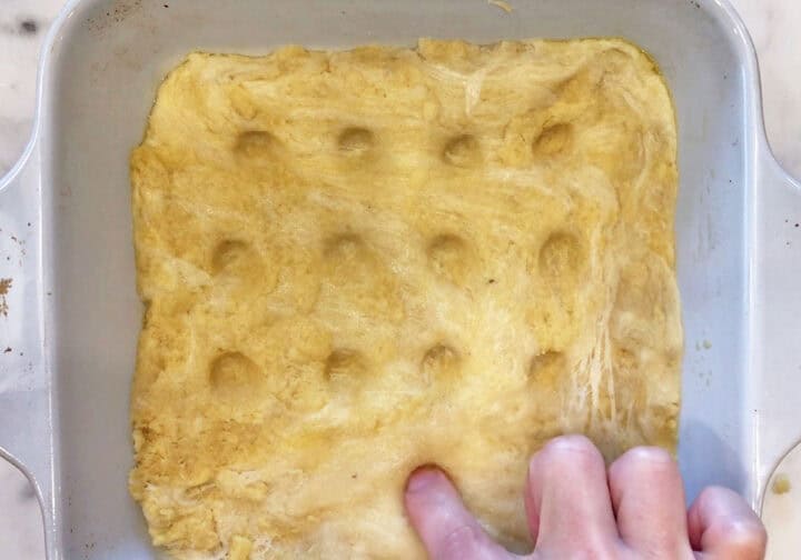 Making dimples in the dough.