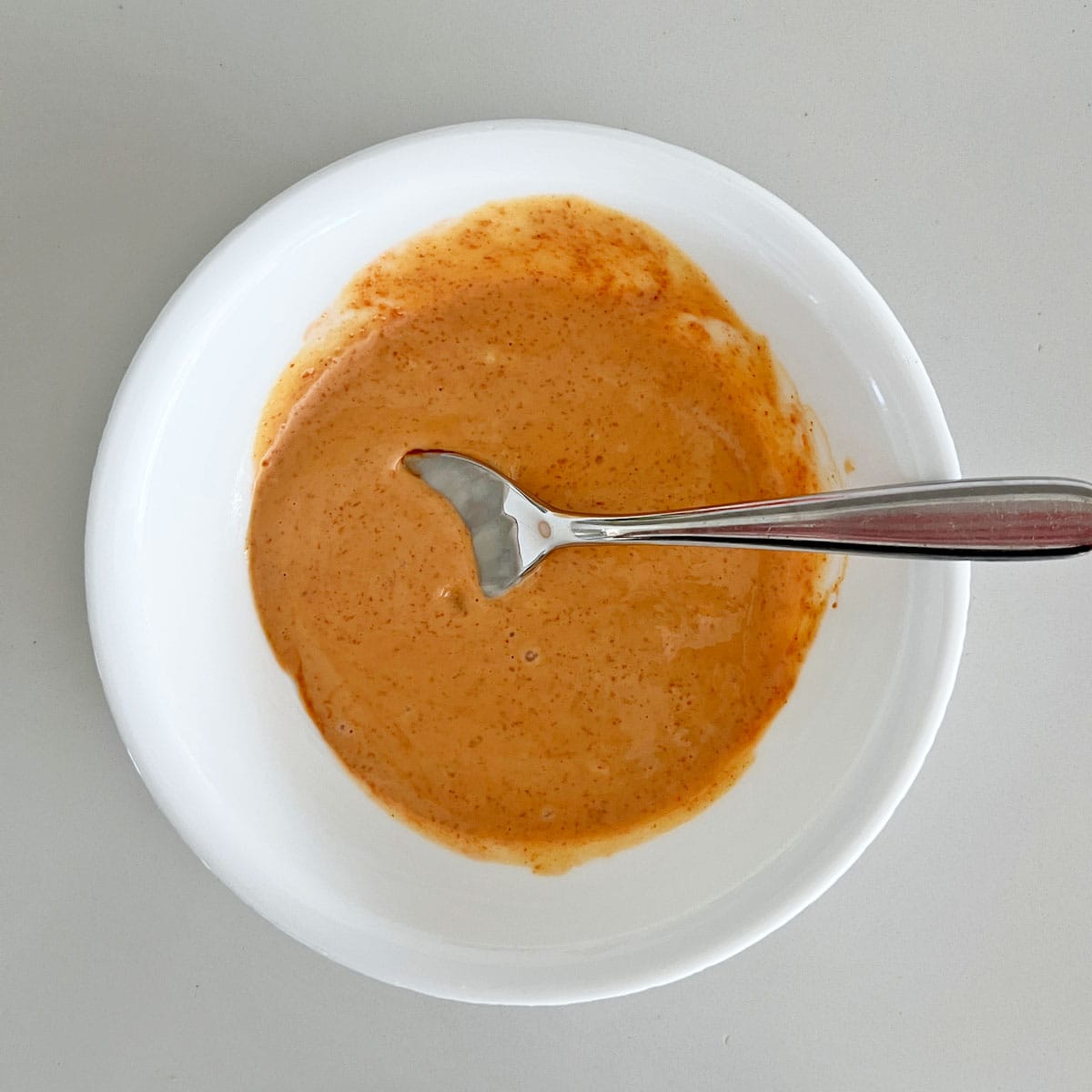 Dipping sauce for okra in a white bowl.