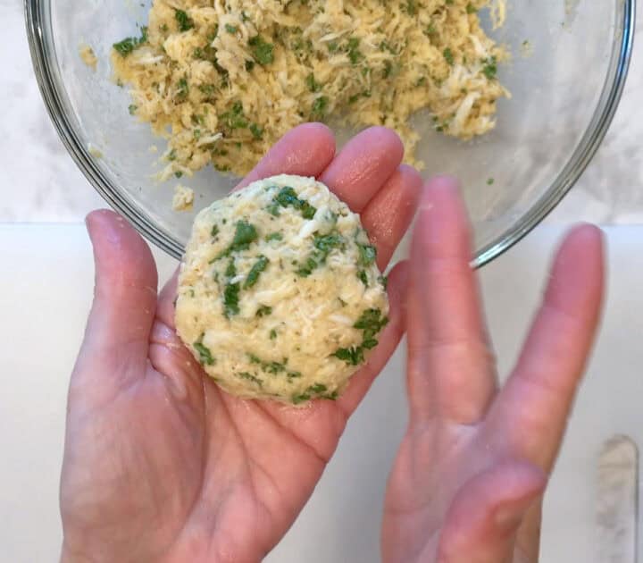Shaping a crab cake.