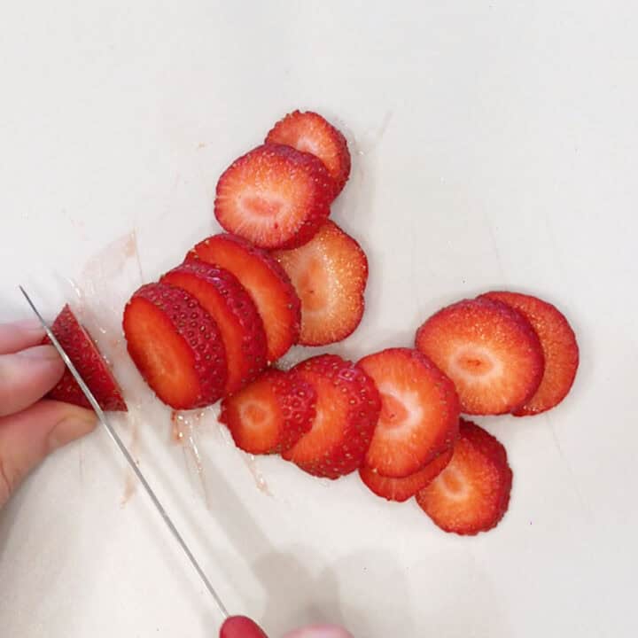 Slicing the strawberries.