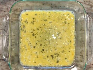 A shallow container with a beaten egg.