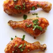 Buffalo drumsticks are served on a white platter.