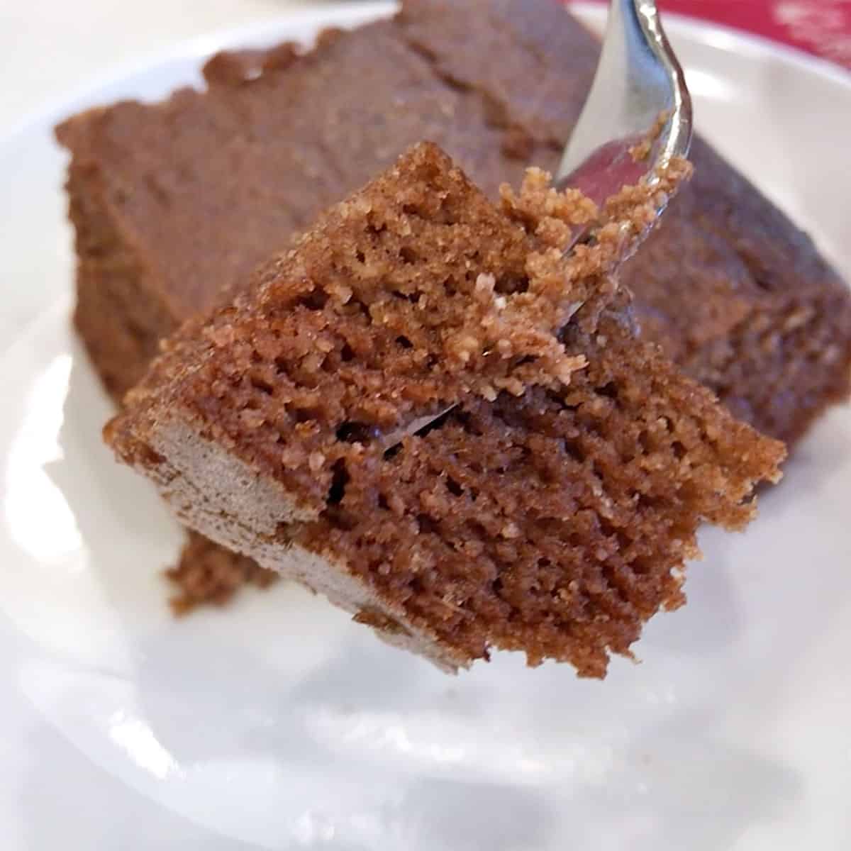 A fork showing off the cake's tender crumb.