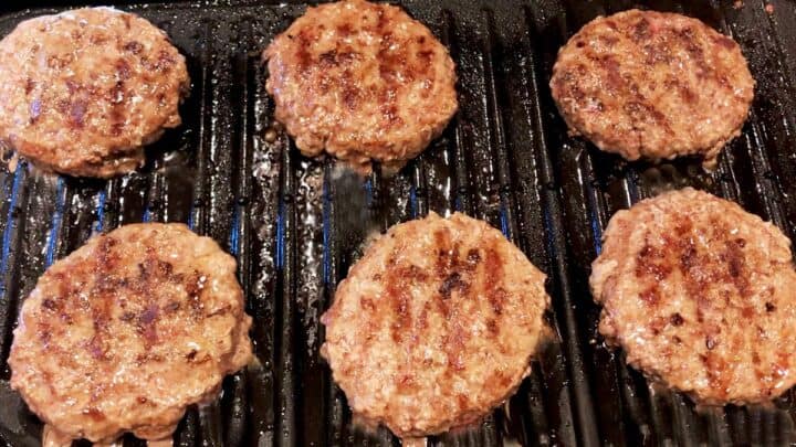 Cooking the beef patties on the grill.
