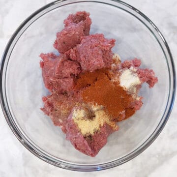 Ground beef and spices in a bowl.