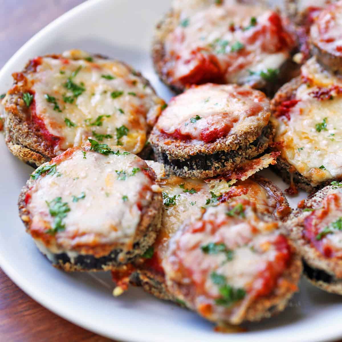 Keto eggplant parmesan is served on a white plate.