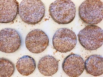 The coated eggplant rounds are on the baking sheet and ready for the oven.
