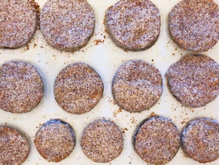The coated eggplant rounds are on the baking sheet and ready for the oven.