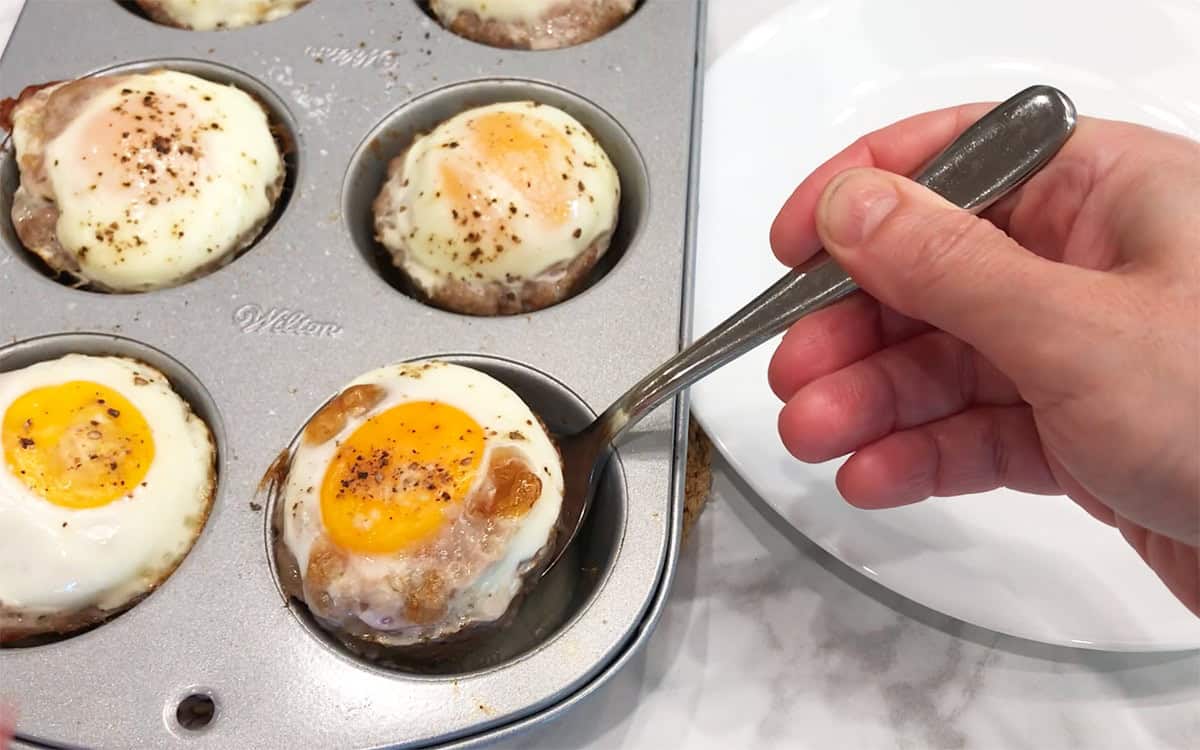 Removing the muffins from the pan.