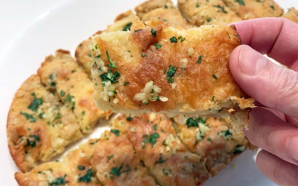 Holding a piece of bread for a closeup.