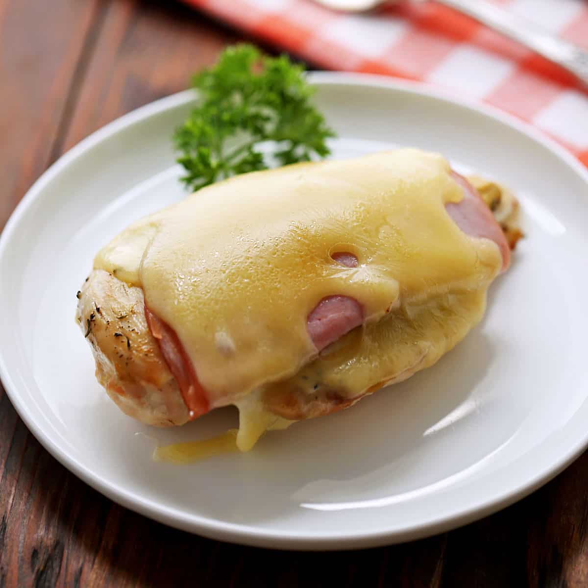 An easy version of chicken cordon bleu on a white plate.