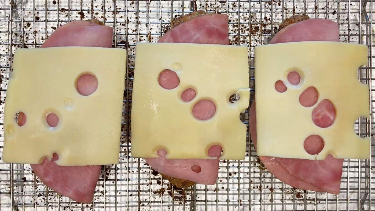 The chicken was topped with ham and cheese.