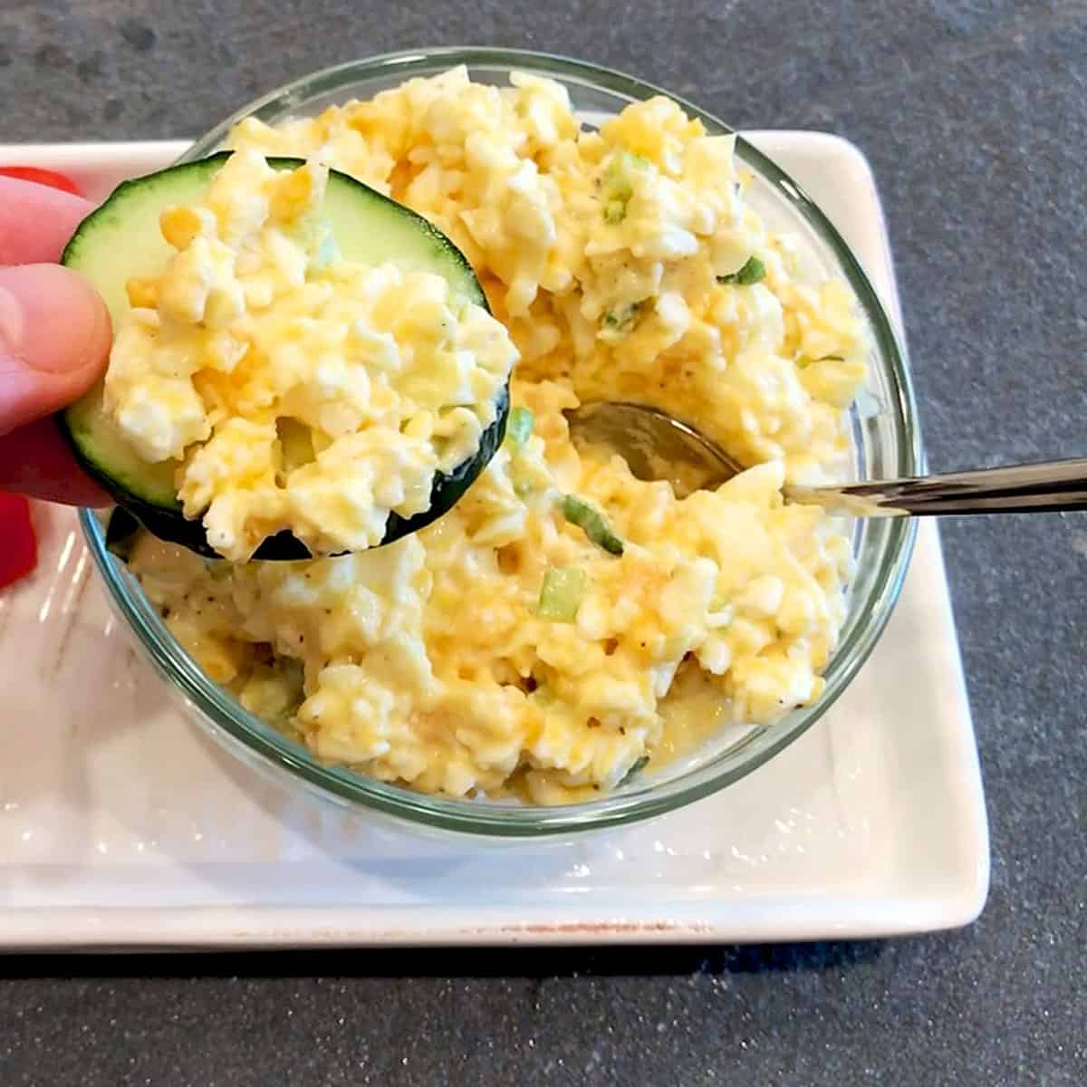 Low-carb egg salad is served on a cucumber slice.