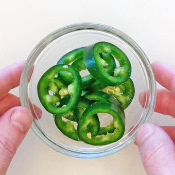 Jalapeno slices in a small bowl.