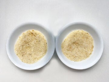 Two bowls with parmesan and spices.