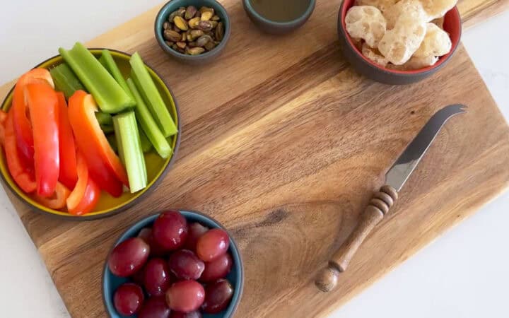 The wooden board is ready for the brie.