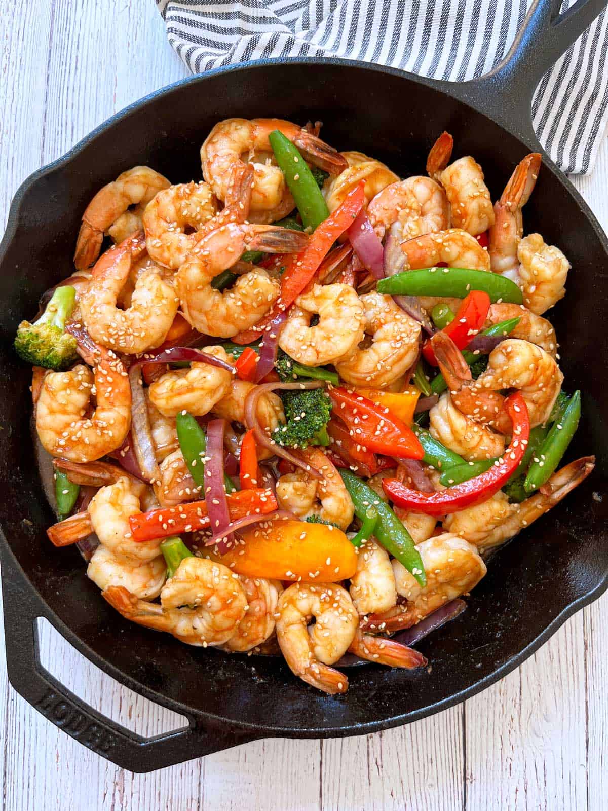 Shrimp stir fry is served in a cast-iron skillet.