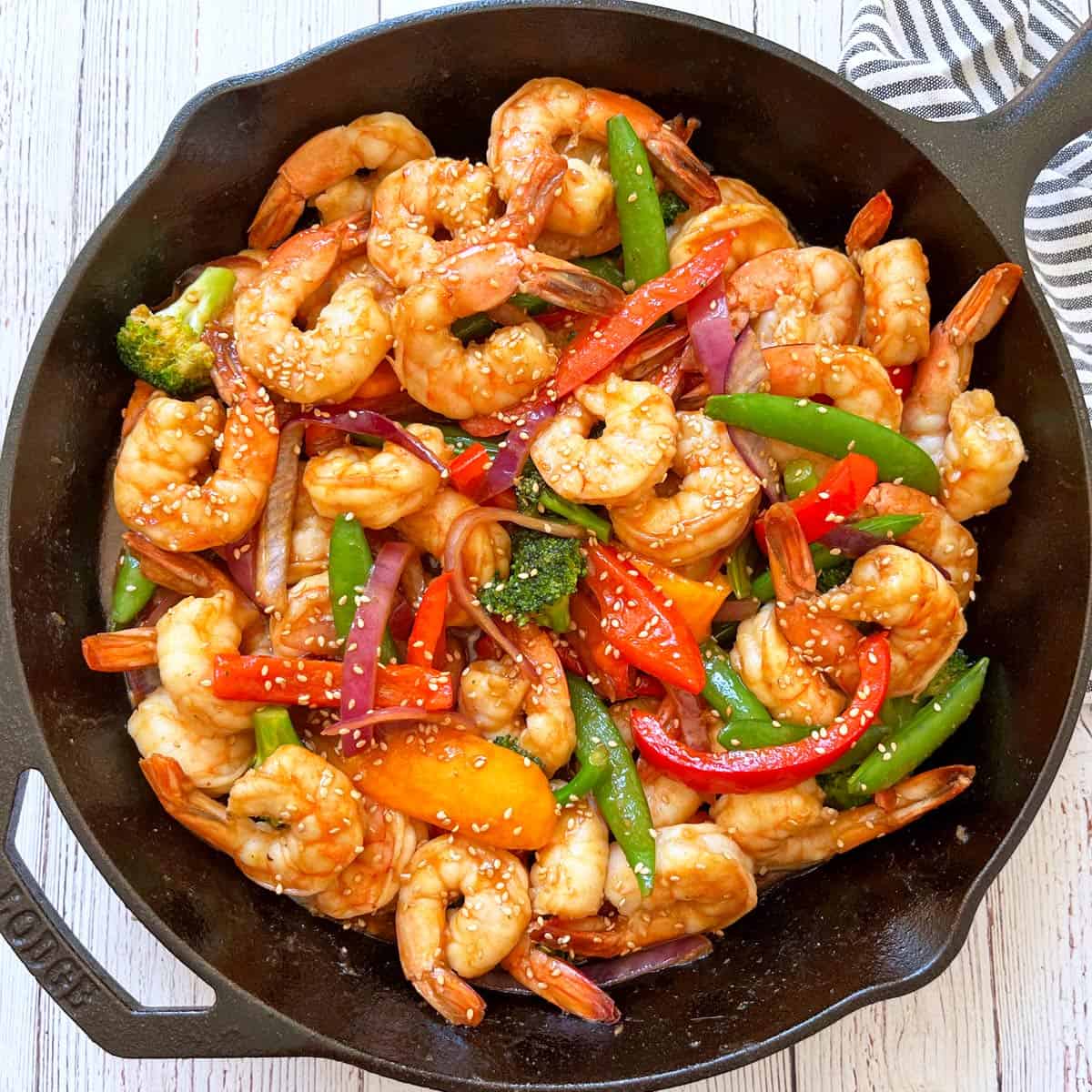 Shrimp stir fry is served in a skillet.