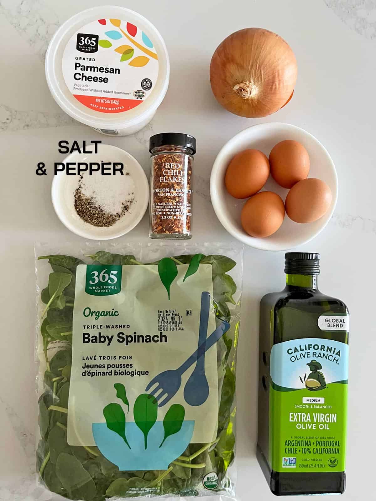 The ingredients needed for a spinach and eggs scramble.