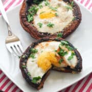Breakfast mushrooms are served on a white plate.