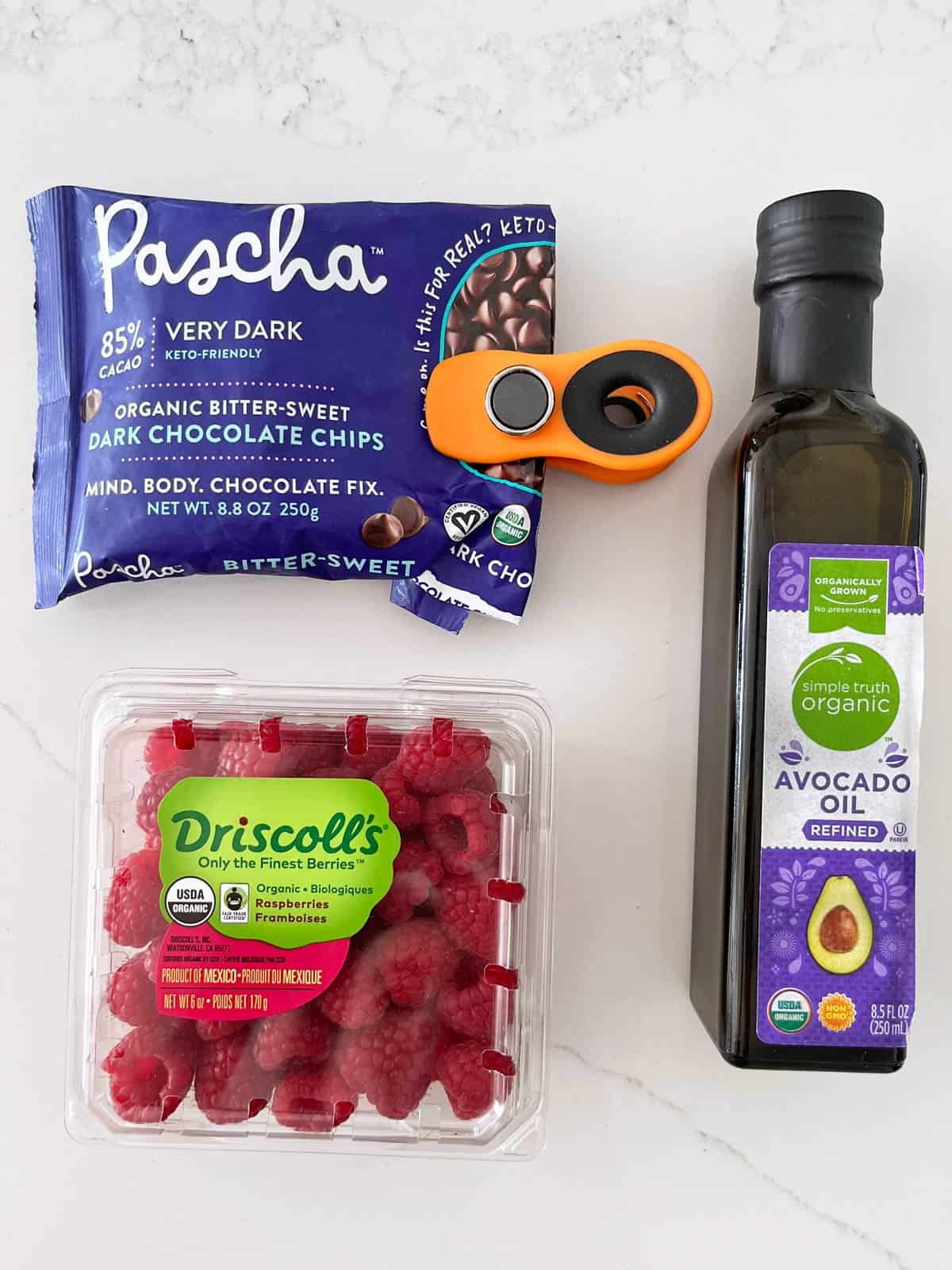 The ingredients needed to make chocolate-covered raspberries.