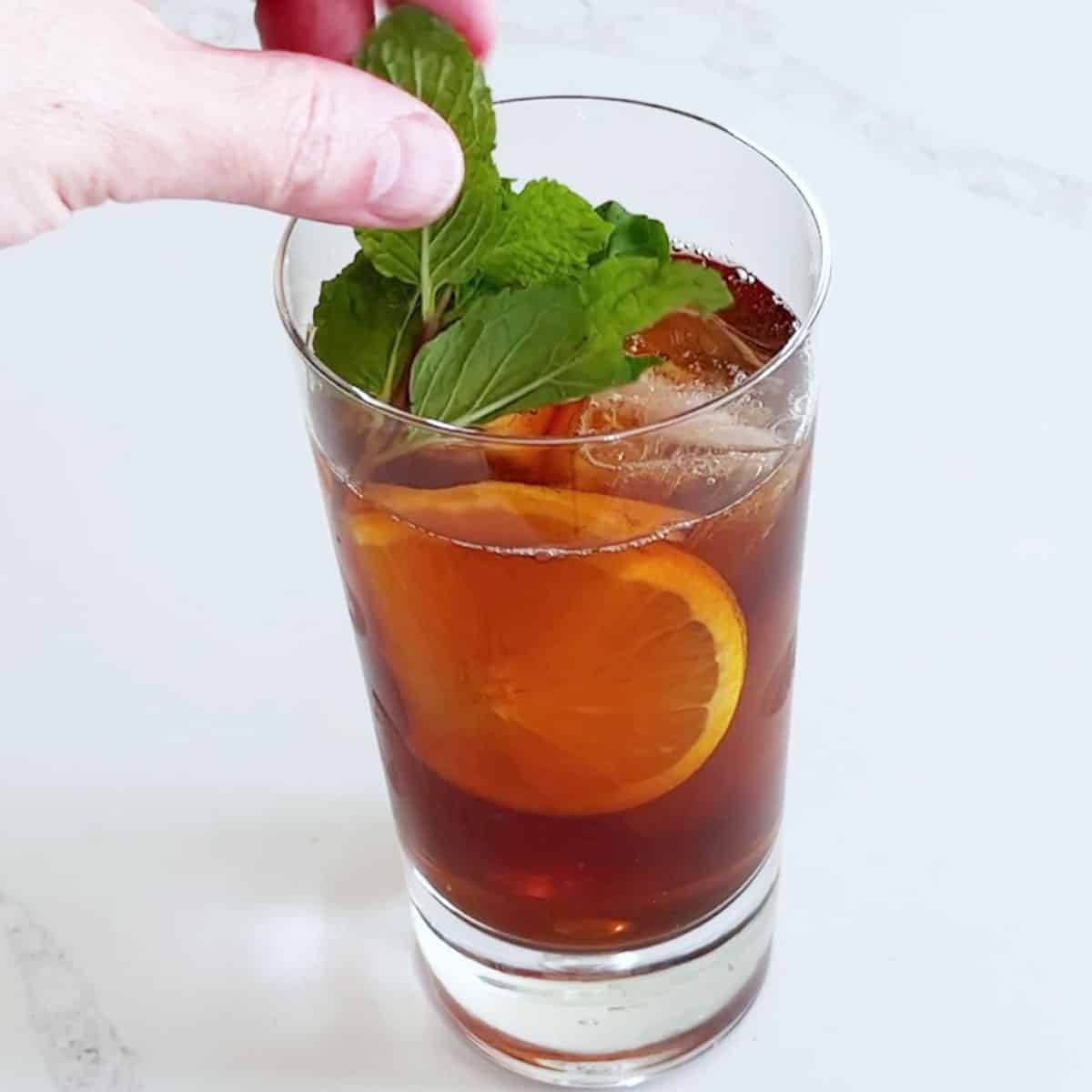 Garnishing the tea with mint.