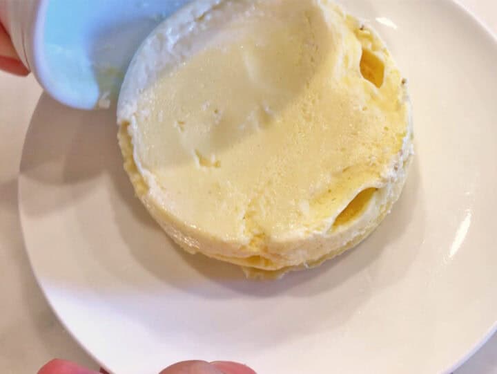 Inverting the cake onto a plate.