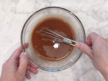 Mixing the sauce in a bowl.