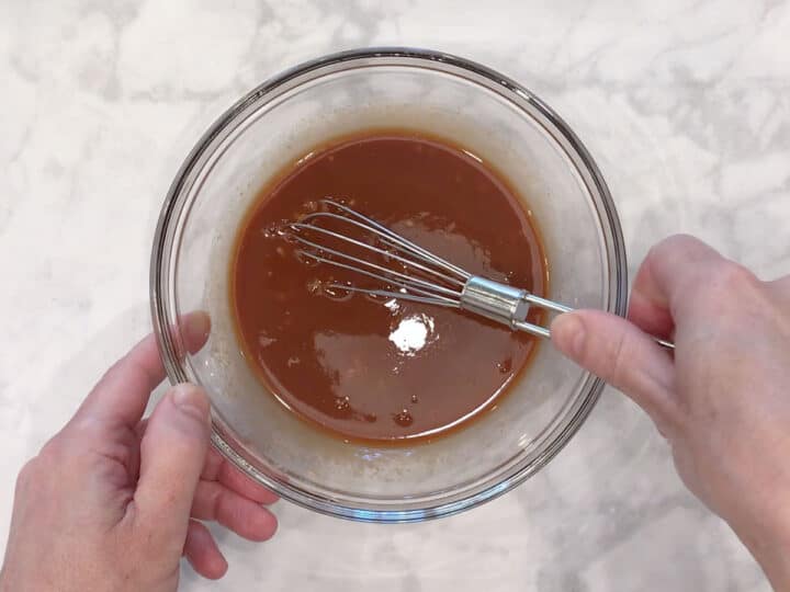 Mixing the sauce in a bowl.