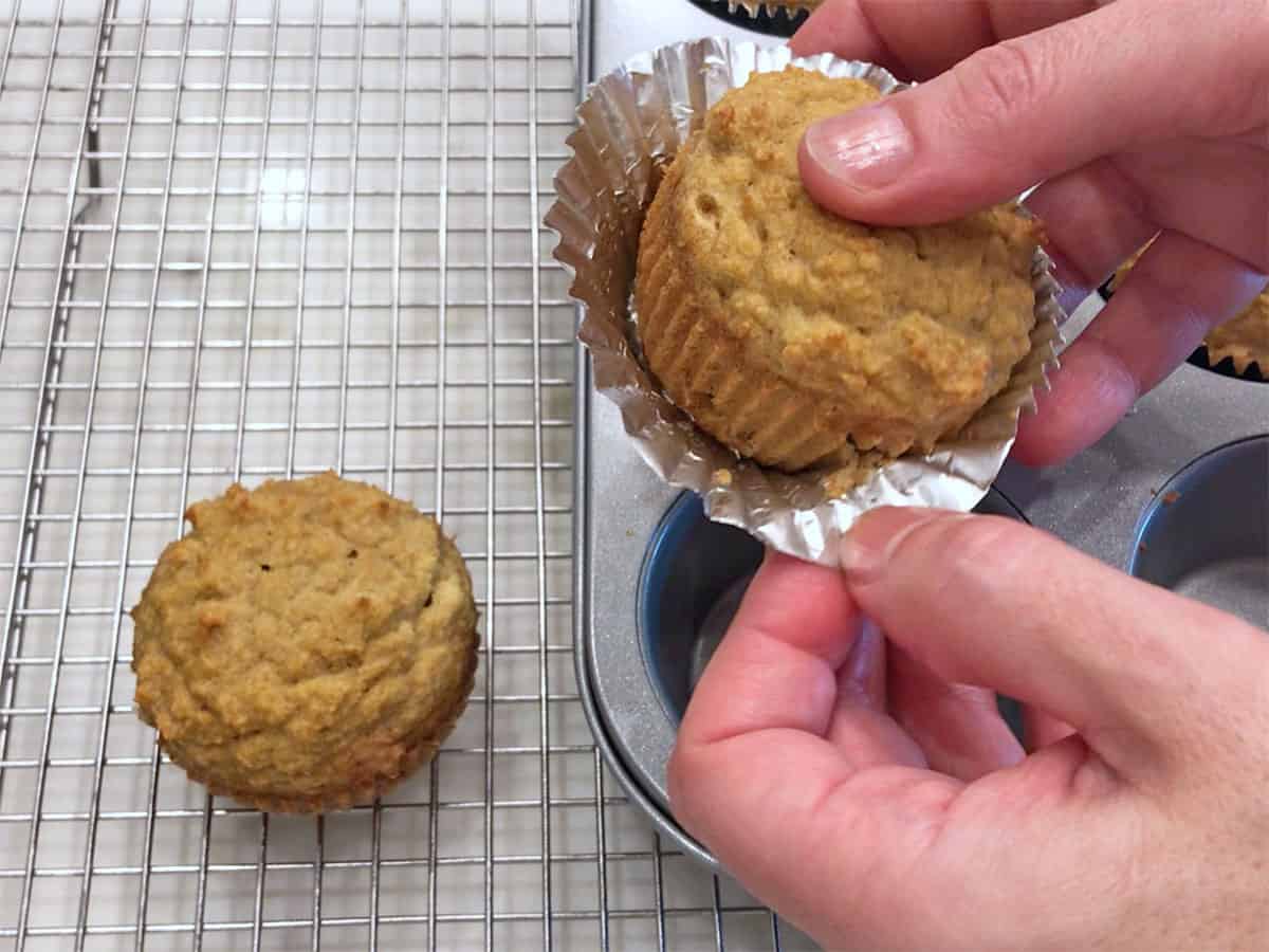 Removing the foil liner from a muffin.
