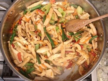 The stir fry is ready in the skillet.