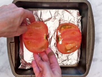 Placing the tomatoes in the pan.