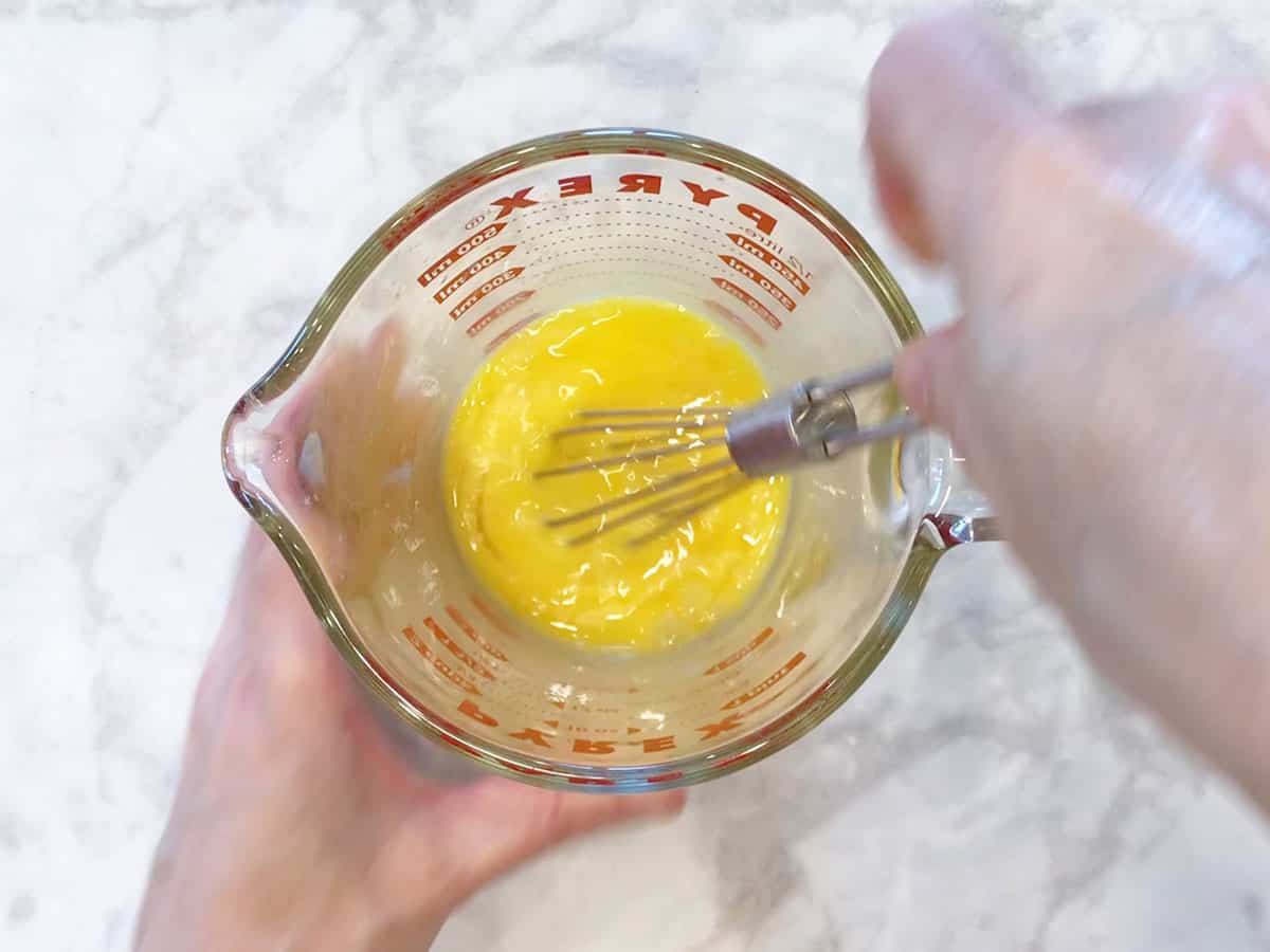 Whisking the eggs.