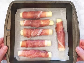 The wrapped mozzarella sticks were arranged in a pan.