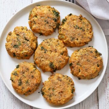 Baked salmon cakes are served on a white plate.