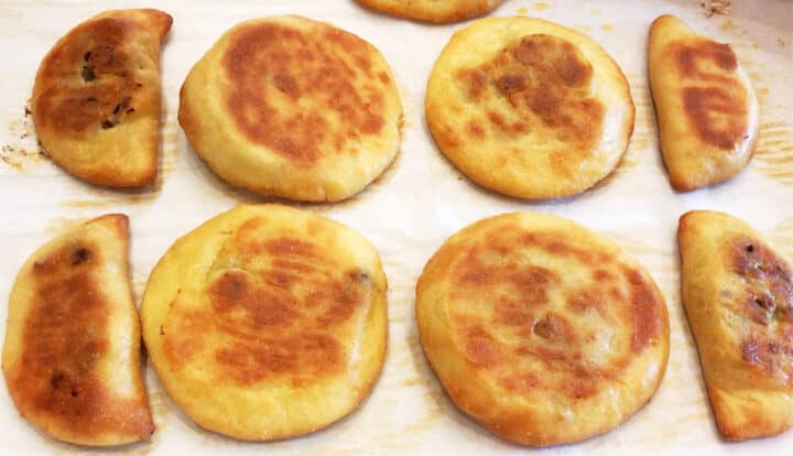 The empanadas are ready on the pan.