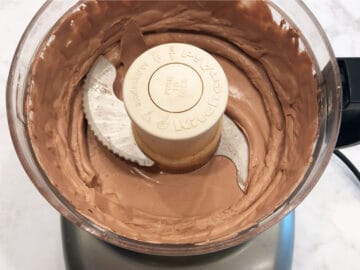 The whipped cream is ready in the food processor.