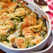 Brussels sprouts casserole is served in a white baking dish.