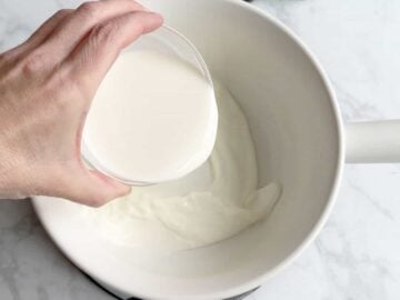 Measuring out the heavy cream.