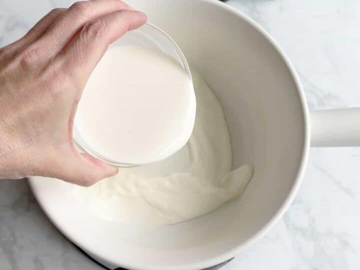 Measuring out the heavy cream.