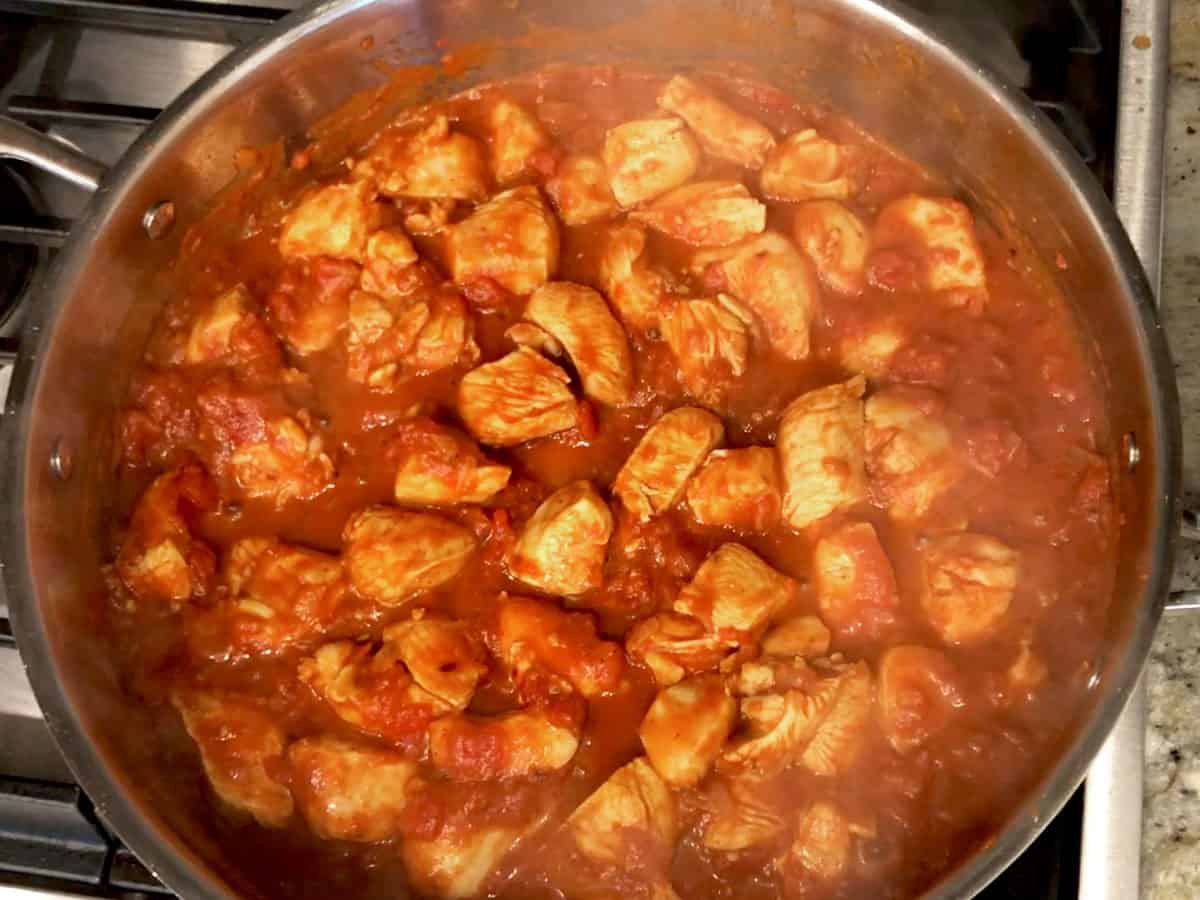 The tomato sauce was added to the skillet.