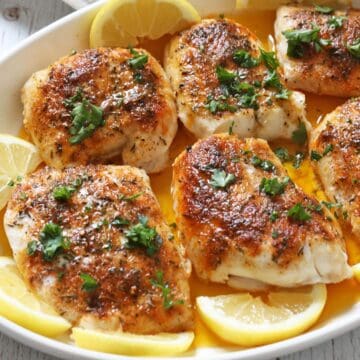 White fish fillets are served in a baking dish.