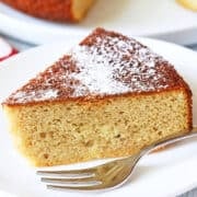 A slice of almond flour cake is served with a small cake fork.