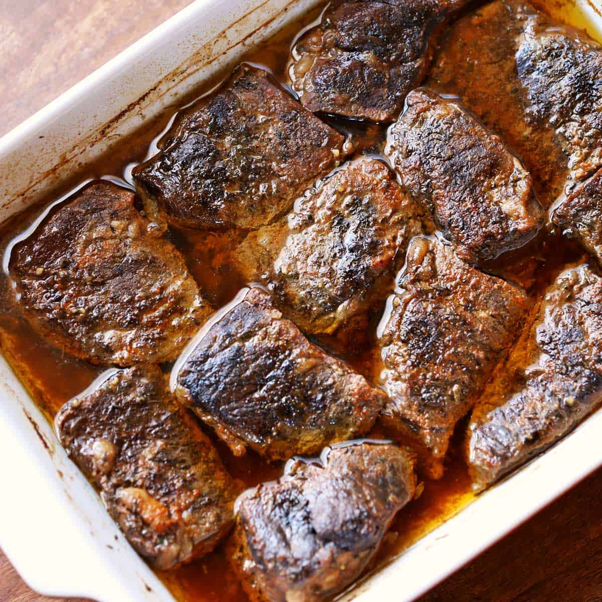 Boneless short ribs in a baking dish.