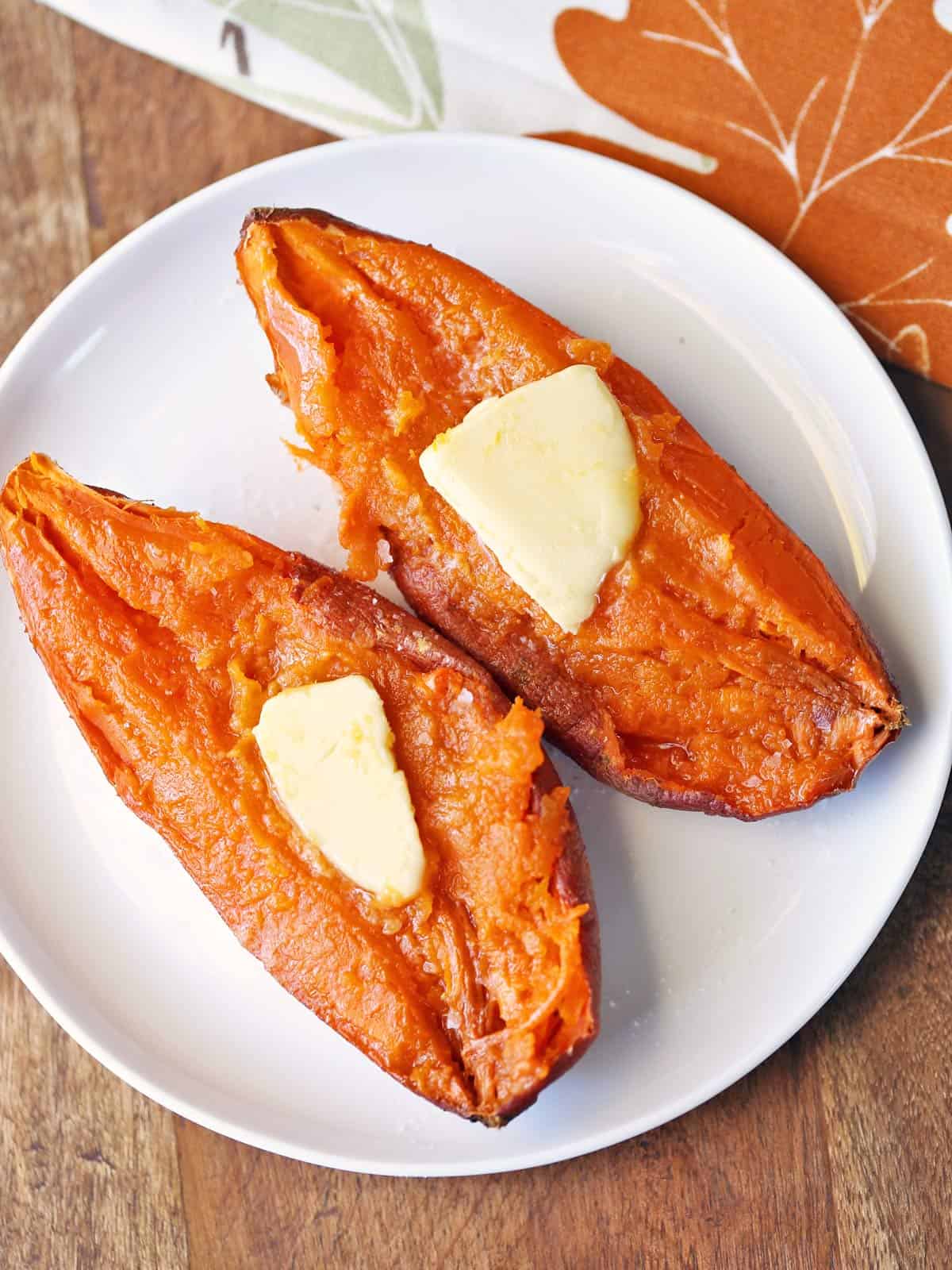 Microwave sweet potato is topped with butter.