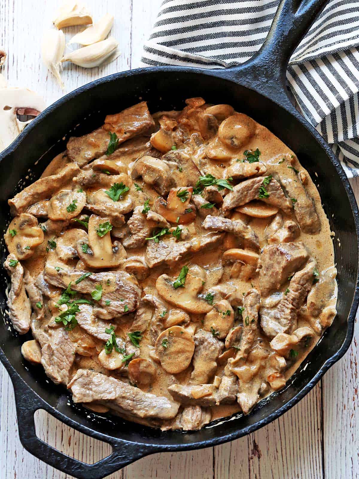 Beef stroganoff is served in a cast-iron skillet.