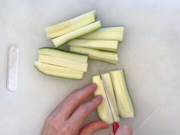 Cutting the zucchini into fries.