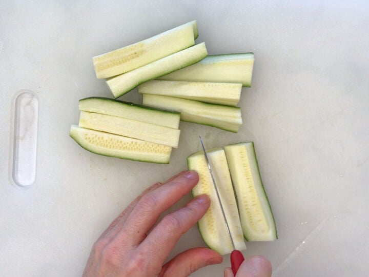 Cutting the zucchini into fries.