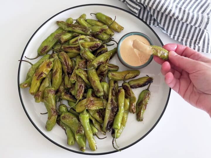 Dipping a pepper into the dip.