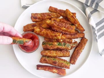 A fry is dipped in ketchup.